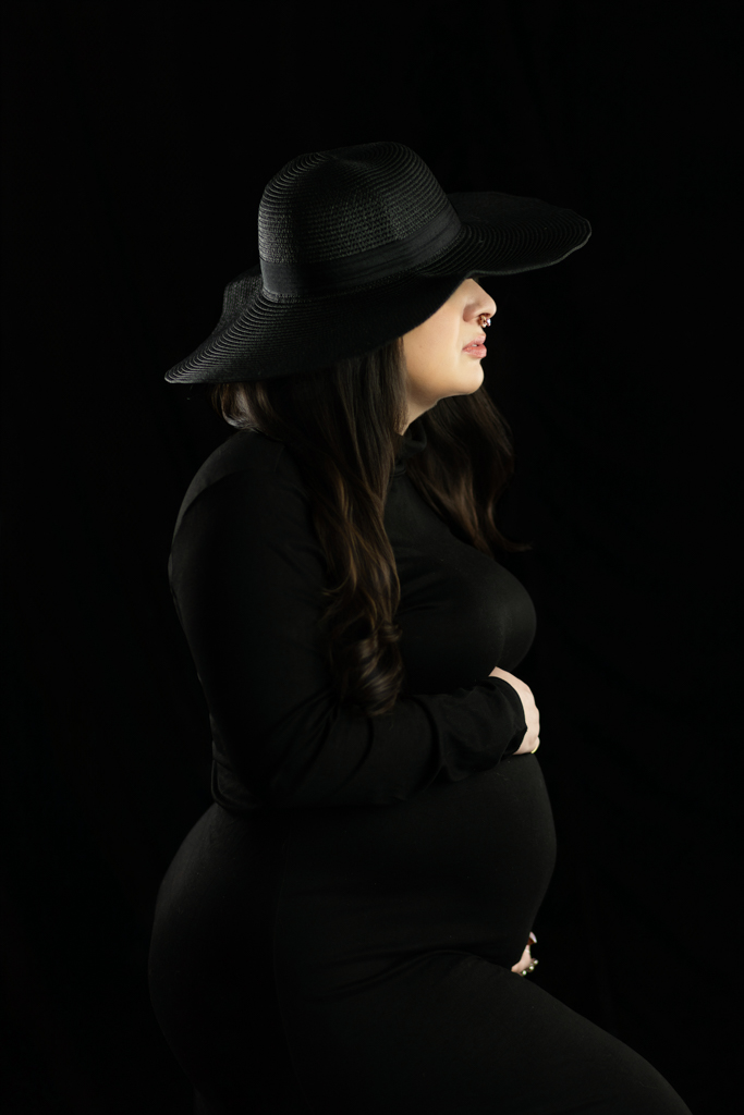 Black and white inspired maternity portrait of pregnant mother wearing wide brim hat