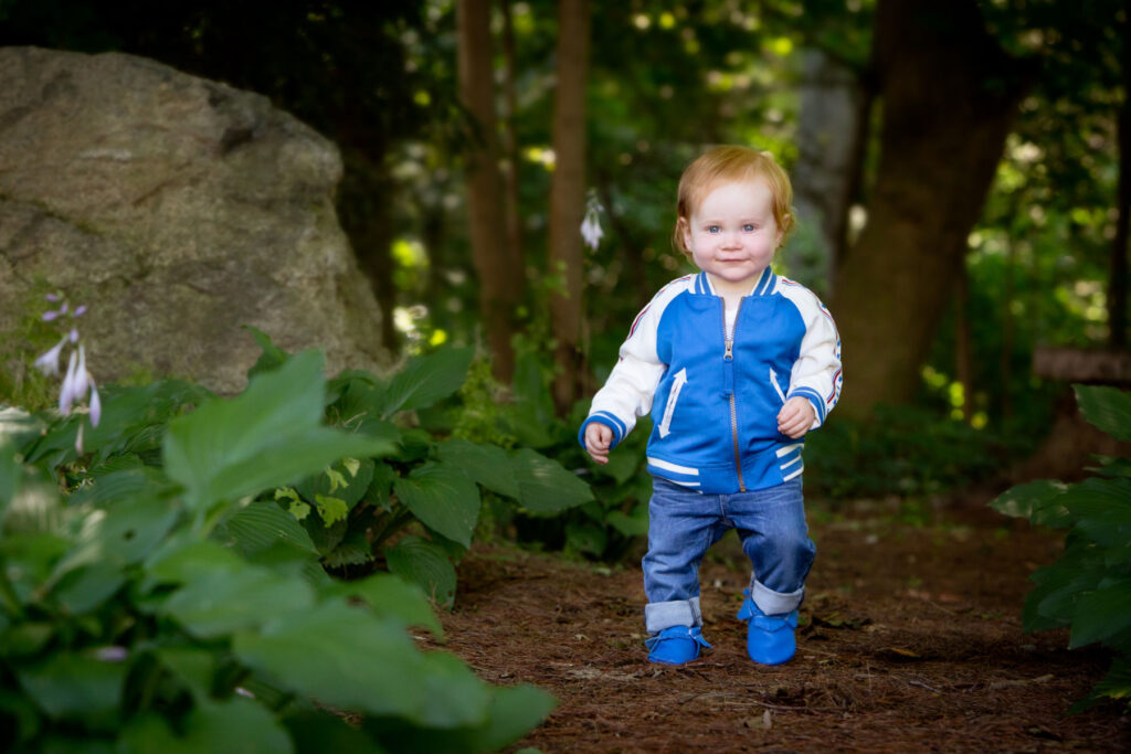 Baby portrait session featuring a child outdoors in natural surroundings