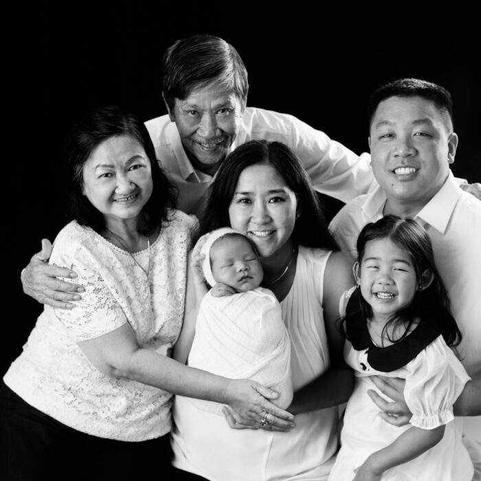 Multi generational family portrait with newborn baby and young child