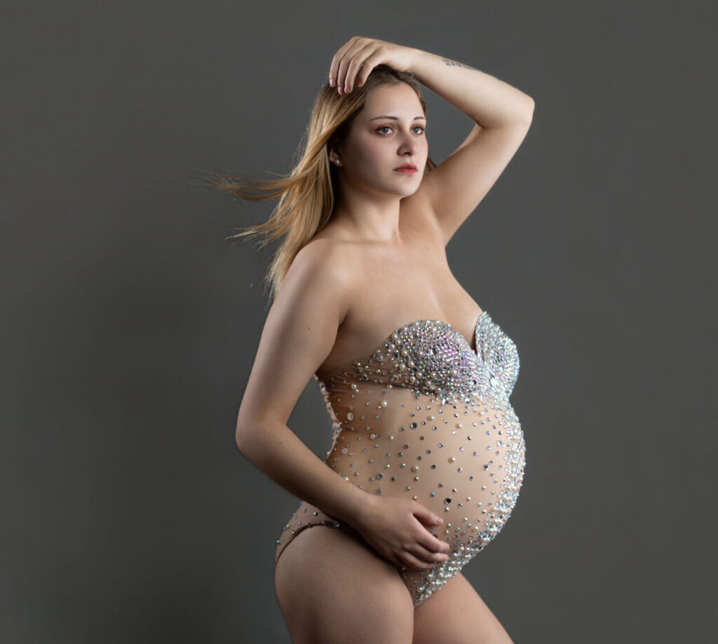 Studio maternity photography of pregnant woman in crystal embellished bodysuit with modern editorial styling