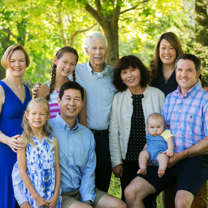 Three-generation family portrait outdoors with grandparents, parents and children
