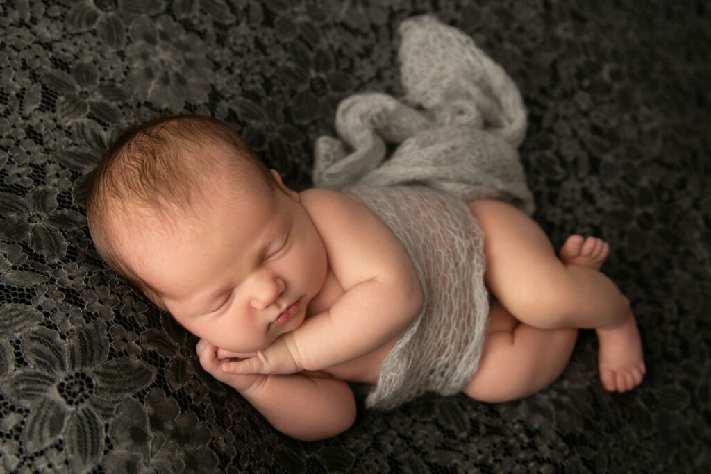 Sleeping newborn baby portrait with classic studio styling