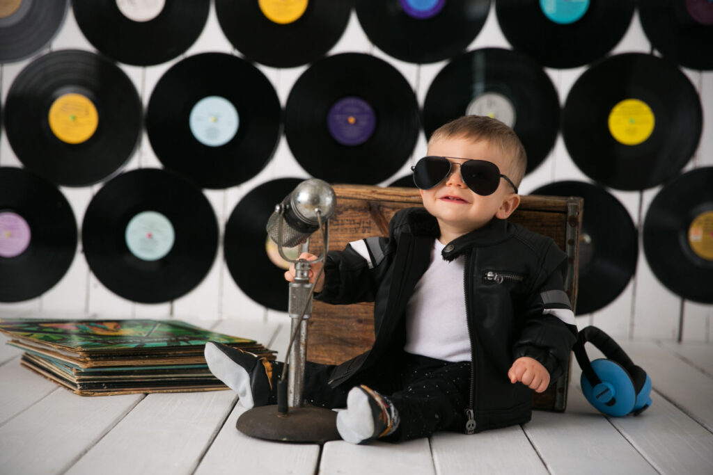 One year old boy in sunglasses during rock and roll themed milestone session
