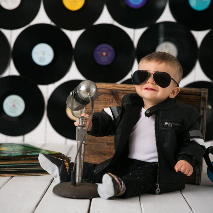 One year old boy in sunglasses during rock and roll themed milestone session
