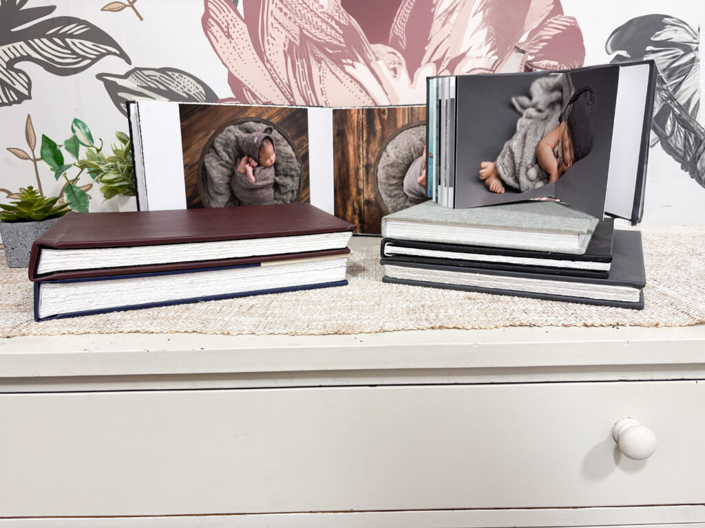 Sample Baby Plan portrait albums from Alternate Angles Photography featuring newborn images and first-year baby milestones