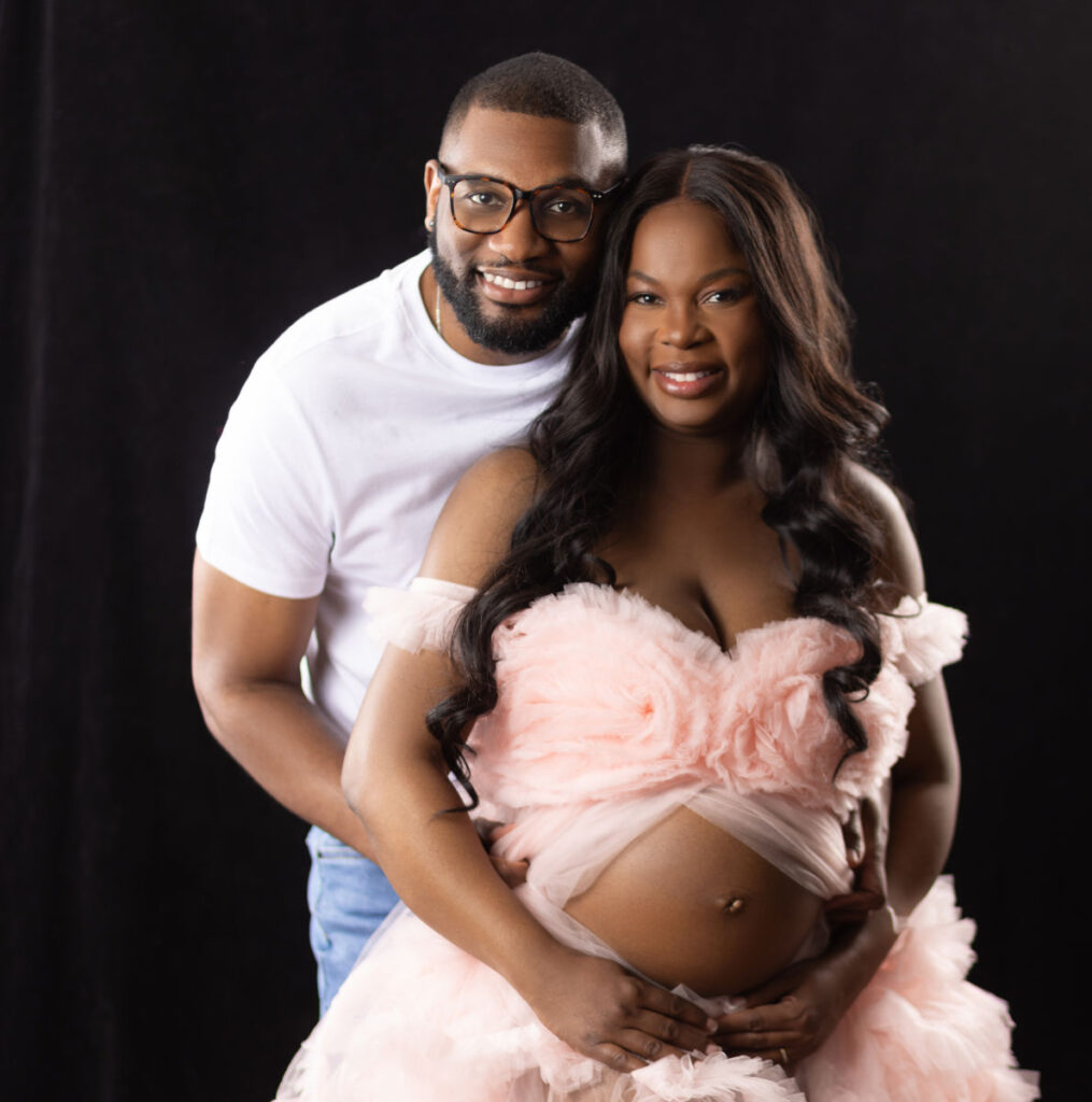 Elegant studio maternity portrait of expecting couple during professional pregnancy photography session