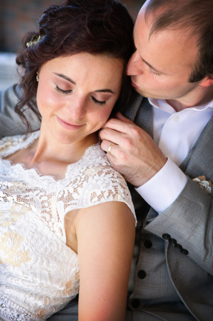 Groom kissing the bride’s hair during a romantic close-up wedding portrait