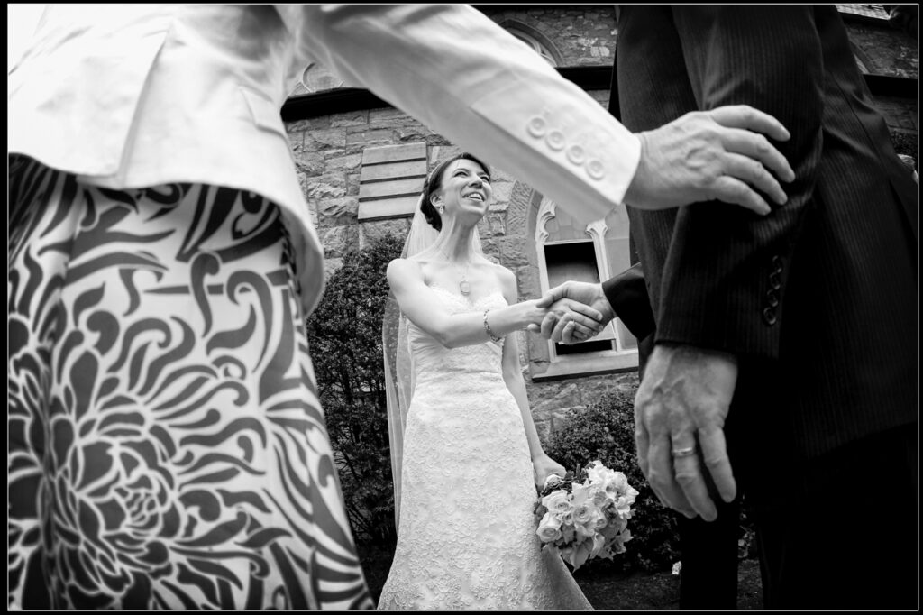 Bride smiling as she greets her grandparents in the receiving line after the wedding ceremony