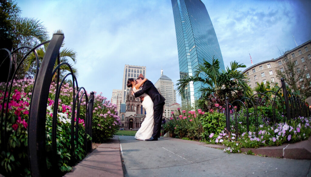 Bride and groom kissing in Copley Square during a Boston Public Library wedding portrait session
