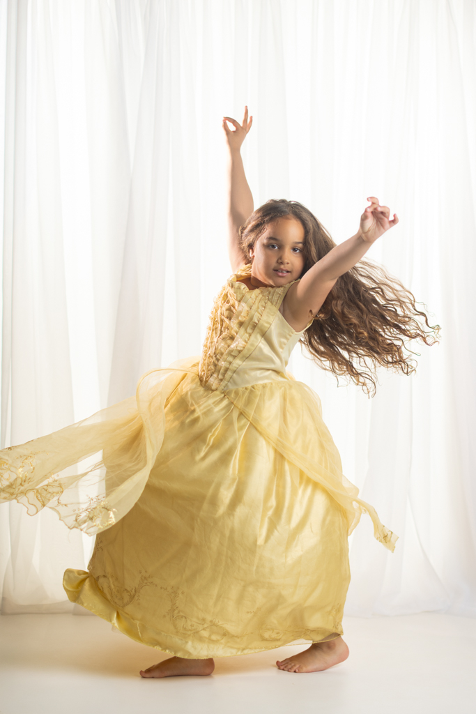 6 year old girl dancing in a princess dress during a movement inspired child portrait photography session