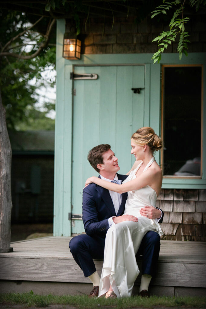 Bride and groom sitting together on a porch during an intimate Nantucket, Massachusetts wedding portrait session